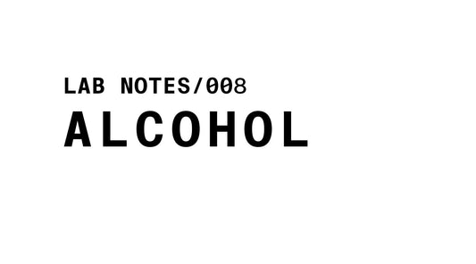The image is a black and white graphic with the words "LAB NOTES/008" at the top left in a smaller, sans-serif font. Below it, in a much larger, bold sans-serif font, is the word "ALCOHOL". The background is plain white.